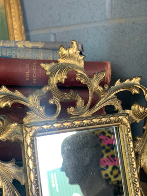 An ornate brass Rococo styled easel back mirror
