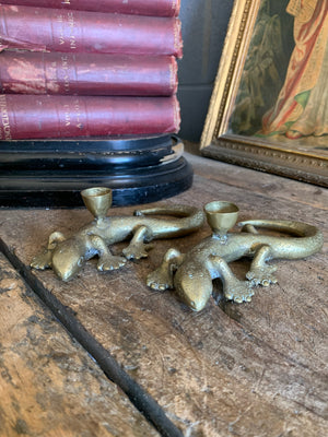 A pair of brass candlesticks in the form of lizards