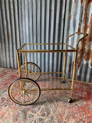 A faux bamboo Hollywood Regency two tier trolley