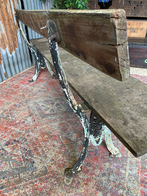 A cast iron and wooden garden bench