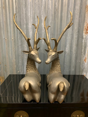 A pair of opposing white metal stags