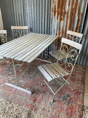 A white garden table and chairs set