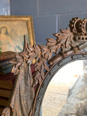 A cast iron table top mirror