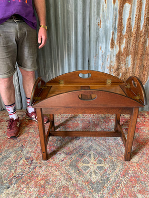 A mahogany butler's tray table