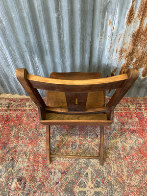 An Edwardian oak folding chapel chair by Mealing Bros