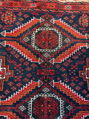 A Persian red & blue ground rectangular rug ~ 179cm x 96cm