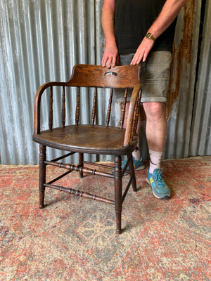 An oak spindle back captain's chair