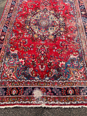 A large red ground Persian rug - 299cm x 194cm