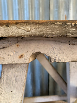 A wooden square-topped sculpture stand