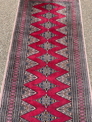 A long pink ground Persian runner rug ~ 318cm x 83cm