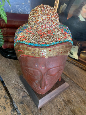 A carved wooden Buddha head