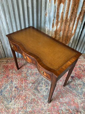 A serpentine desk and leather chair by Bevan Funnell