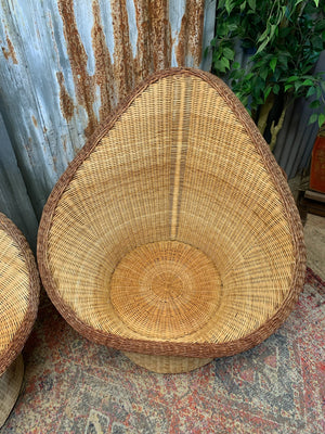 A pair of wicker egg chairs