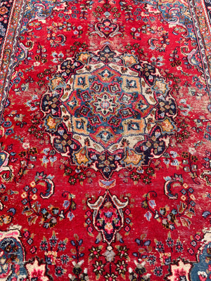 A large red ground Persian rug - 299cm x 194cm