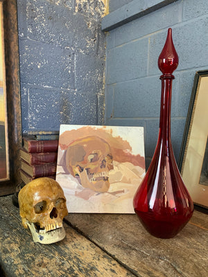 A large red glass carboy