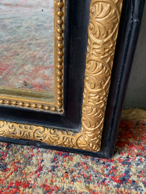 A large French black and gold mirror