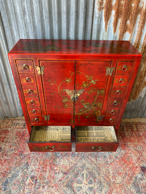 A red and gold lacquered chinoiserie cabinet