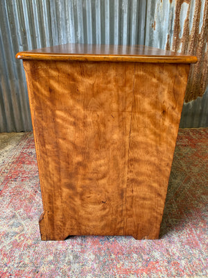 A satinwood chest of drawers