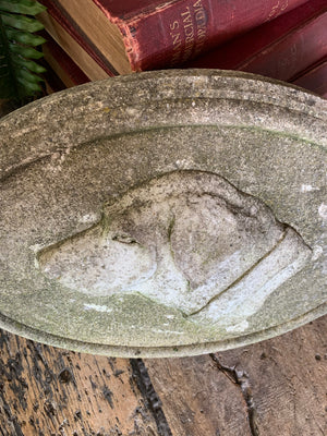 An oval cast stone plaque depicting a dog's head in profile ~B