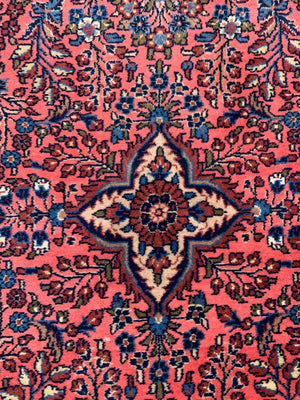 A Persian pink ground wool rug ~ 155cm x 105cm