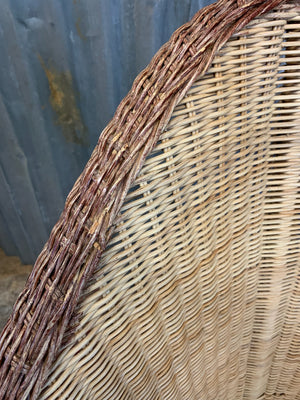 A pair of wicker egg chairs