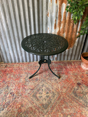 A green garden table and chairs set