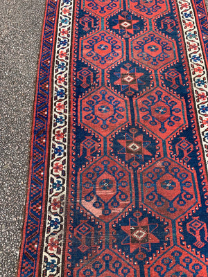 A long red ground blue Persian runner rug ~ 304cm x 104cm