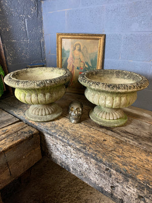 A pair of large cast stone gadrooned urns