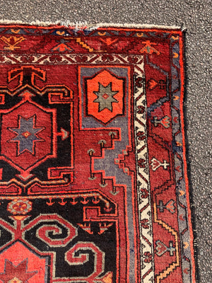 A Turkish red ground rug ~ 211cm x 138cm