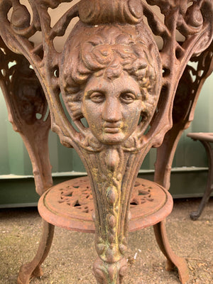 A cast iron Britannia garden table with marble top