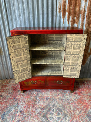 A red and gold lacquered chinoiserie cabinet