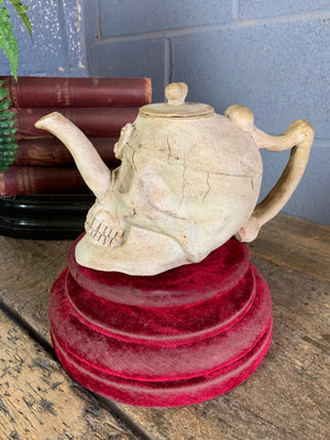 A ceramic teapot in the form of a human skull