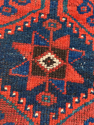 A long red ground blue Persian runner rug ~ 304cm x 104cm