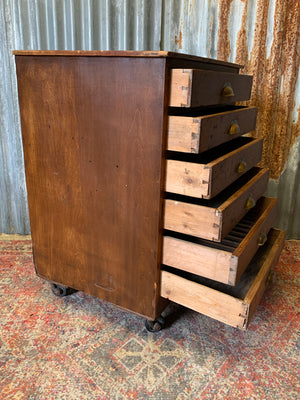 A pine chest of six drawers on castors