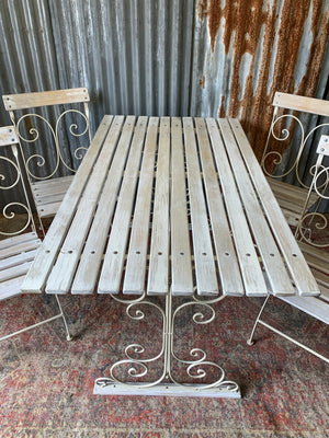 A white garden table and chairs set