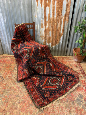 A Persian red & blue ground rectangular rug ~ 179cm x 96cm