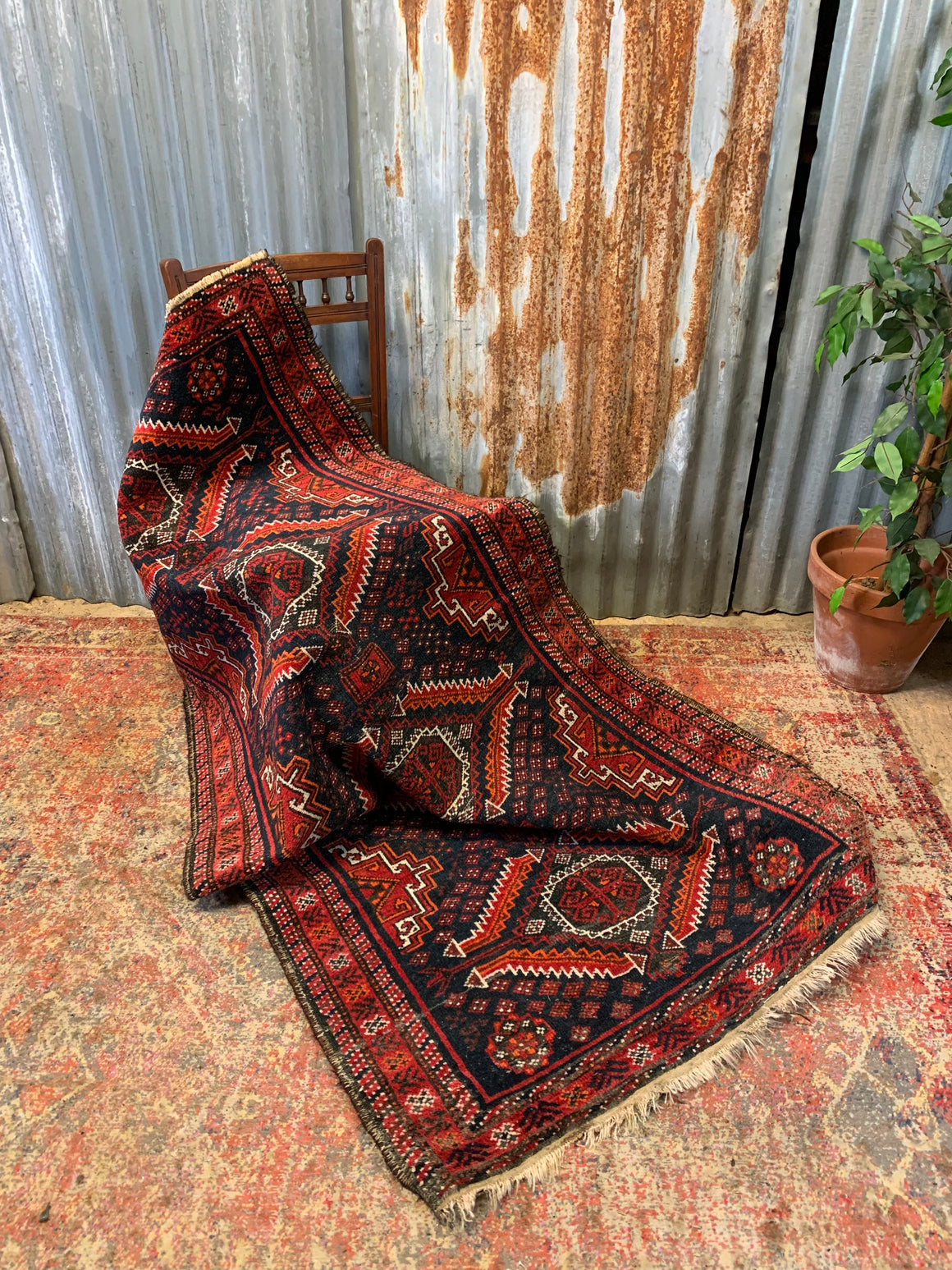 A Persian red & blue ground rectangular rug ~ 179cm x 96cm