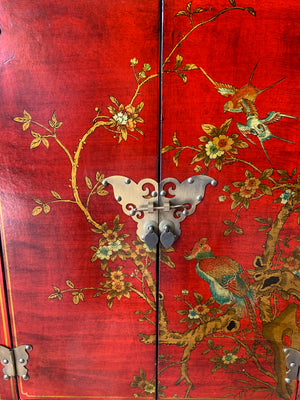 A red and gold lacquered chinoiserie cabinet