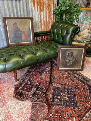 A Victorian-style green leather chaise longue