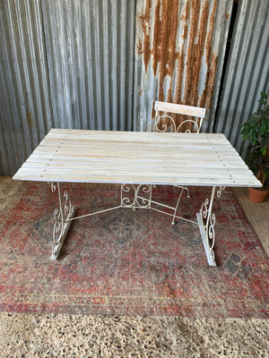 A white garden table and chairs set
