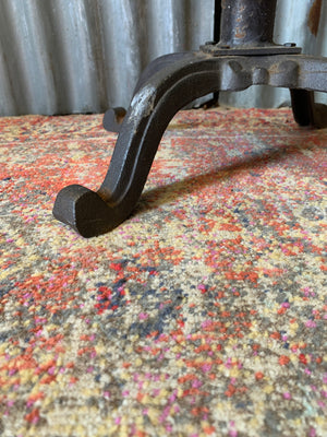 A cast iron adjustable tractor seat stool