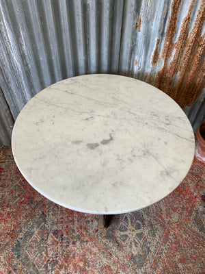 A cast iron Britannia garden table with marble top