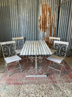 A white garden table and chairs set
