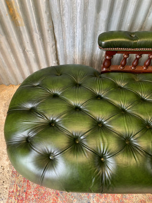 A Victorian-style green leather chaise longue