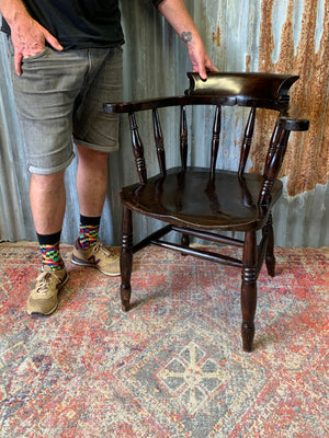 A dark wood captain's chair