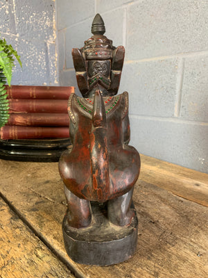 A carved wooden Manussiha sphinx statue