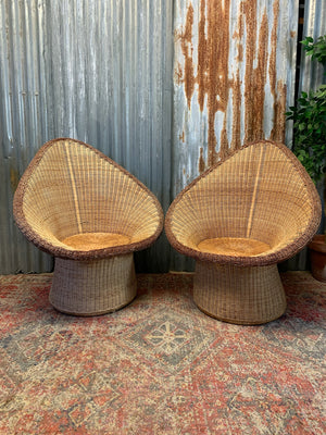 A pair of wicker egg chairs