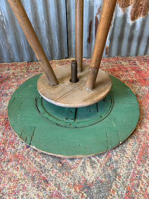 A sculptor's stand with circular oak top