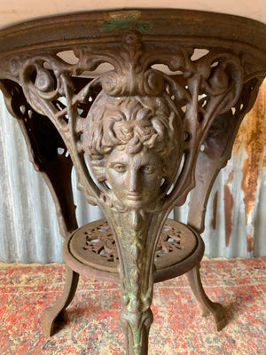 A cast iron Britannia garden table with marble top