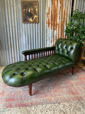 A Victorian-style green leather chaise longue